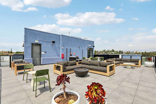 A blue building with a patio furniture set in front of it.