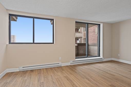 A room with a large window and a sliding glass door.