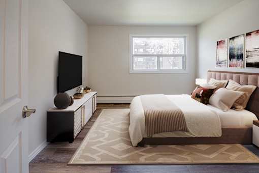 A bedroom with a large bed and a flat screen TV.