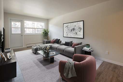 A living room with a grey sofa and a red armchair.