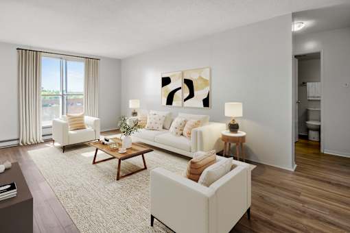 A living room with a white couch, a coffee table, and a painting on the wall.