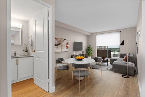 A modern living room with a dining table and chairs.
