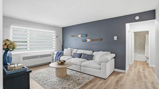 A living room with a white sofa and a coffee table.