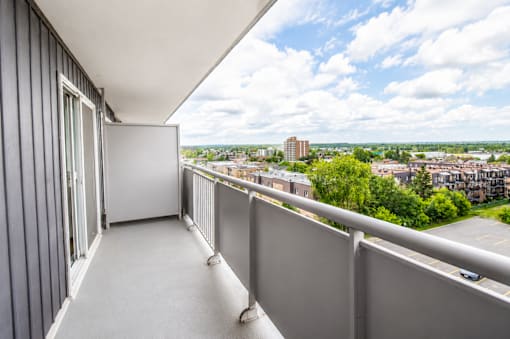 A balcony with a view of a cityscape.