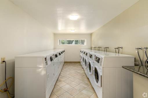 a washer and dryer laundry room with two sets of washing machines