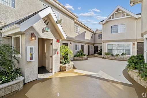 A building with a white entrance and a red fire extinguisher.