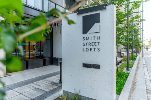 a sign in front of a building that says smith street lofts
