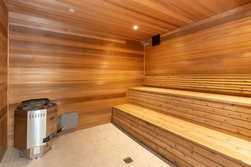 a wooden sauna with a wood wall and floor