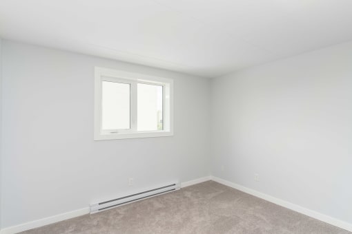 an empty room with a small window