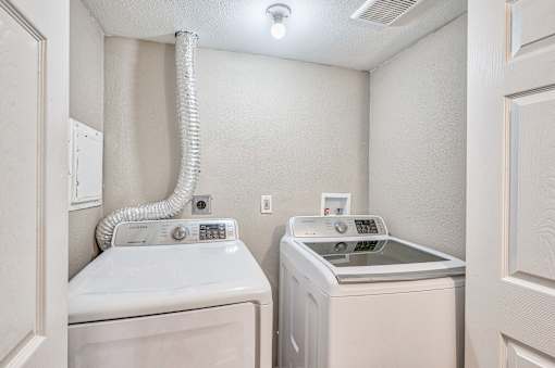 A laundry room with a washer and dryer.