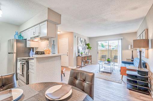 A modern kitchen with a refrigerator, stove, and oven.
