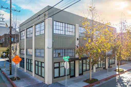 A building with a green street sign in front of it.