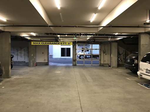 A parking garage with a sign that says "MAX CLEARANCE 6 FT 8"".