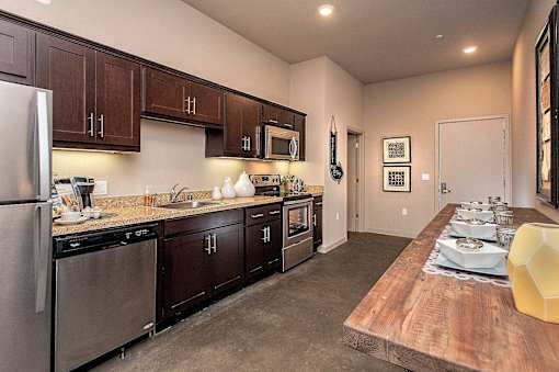 A kitchen with dark wood cabinets and stainless steel appliances.
