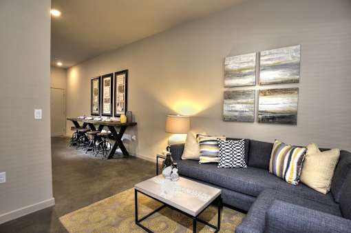 A living room with a grey couch and a coffee table.