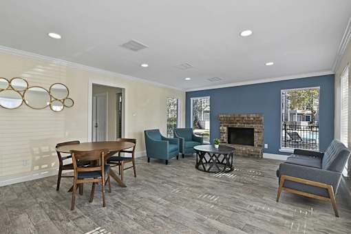 A living room with a fireplace and a dining table.