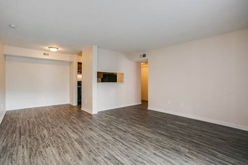 A room with a wooden floor and white walls.
