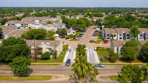 A residential area with houses and cars.