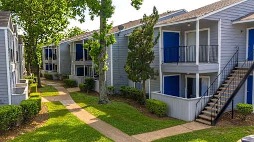 A row of houses with blue doors and windows.