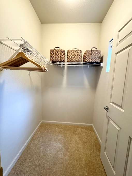 White closet with hanger at Wilsonville Summit Apartments, Wilsonville , Oregon