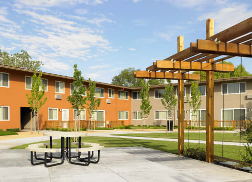a picnic area in front of an apartment building