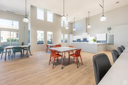 A conference room with a long table surrounded by chairs.