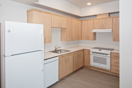 a kitchen with white appliances and wooden cabinets