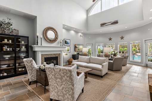 A living room with a fireplace and a large mirror on the wall.