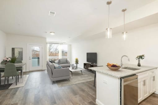 a living room with a couch and a kitchen