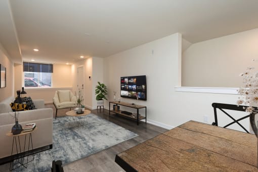a living room with a couch and a table and a tv