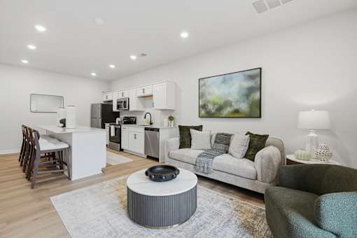 A modern living room with a grey coffee table in the center.
