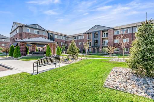A large grassy area in front of apartment buildings.