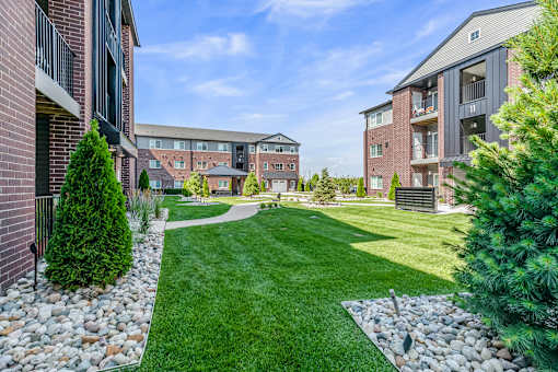A grassy area in front of apartment buildings.