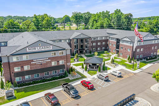 A large brick building with a sign that says "Now Leasing" on the front.