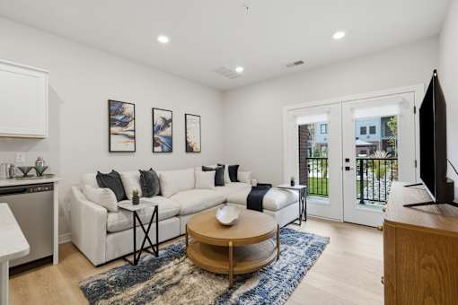 A living room with a white couch and a coffee table.