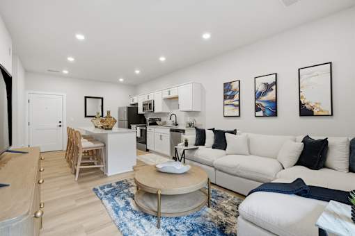A modern living room with a white couch and a coffee table.