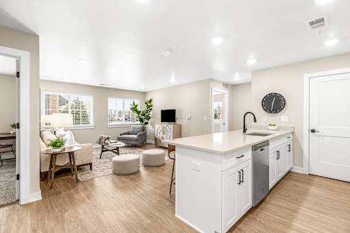 A modern kitchen with white cabinets and a large island.
