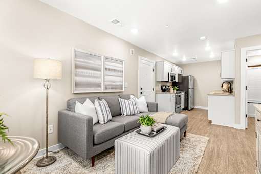 A living room with a grey couch and a coffee table.