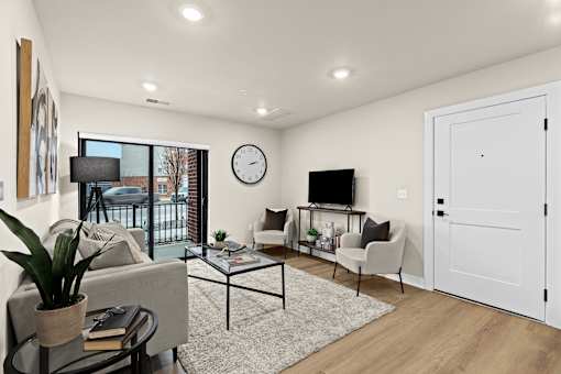 A modern living room with a glass table and a white sofa.