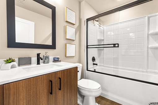 A bathroom with a white toilet and a white sink.