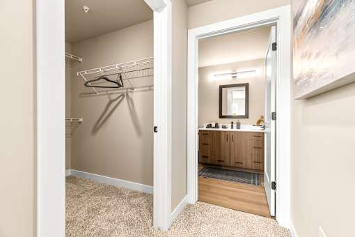 A room with a mirror and a wooden cabinet.