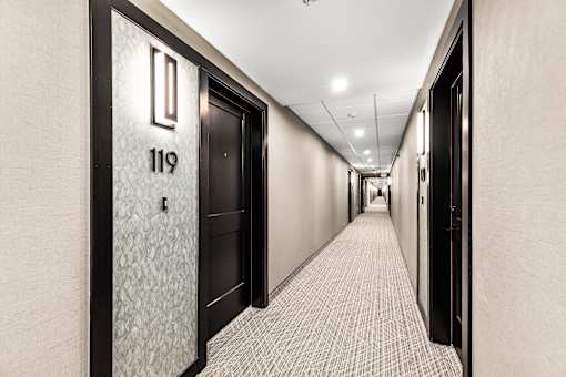 A hallway with doors numbered 119 and 118.