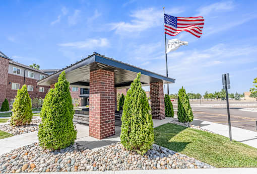 A small building with an American flag on top of it.