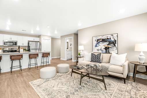 A modern living room with a bar area and a rug on the floor.
