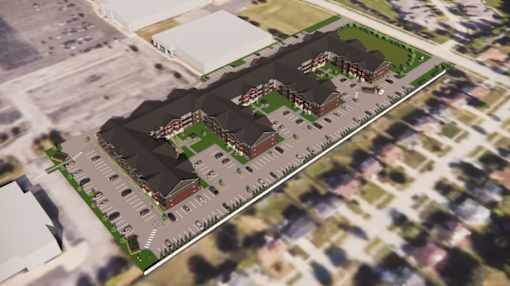 A bird's eye view of a residential area with houses and a parking lot.