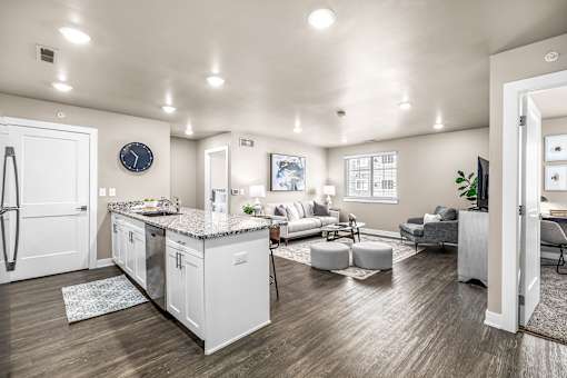 A modern kitchen with white cabinets and a large island.