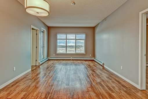 A room with wooden floors and a large window.