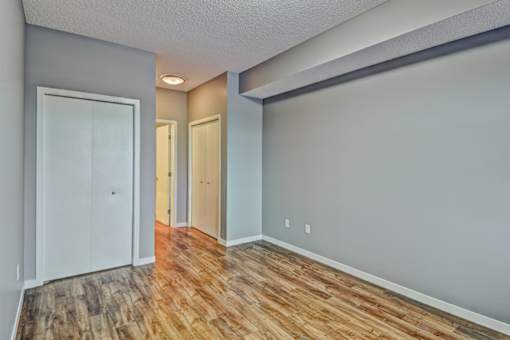 A room with wooden floors and white walls.