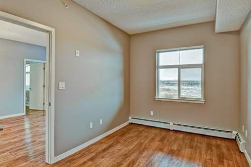 A room with a window and a door.