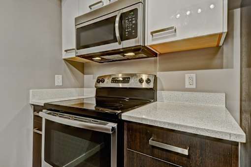 A modern kitchen with a microwave oven mounted above a stove.